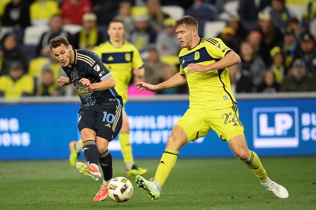 Apr 6, 2024; Nashville, Tennessee, USA; Philadelphia Union midfielder Daniel Gazdag (10) passes the ball as Nashville SC defender Josh Bauer (22) closes him down during the second half at Geodis Park.