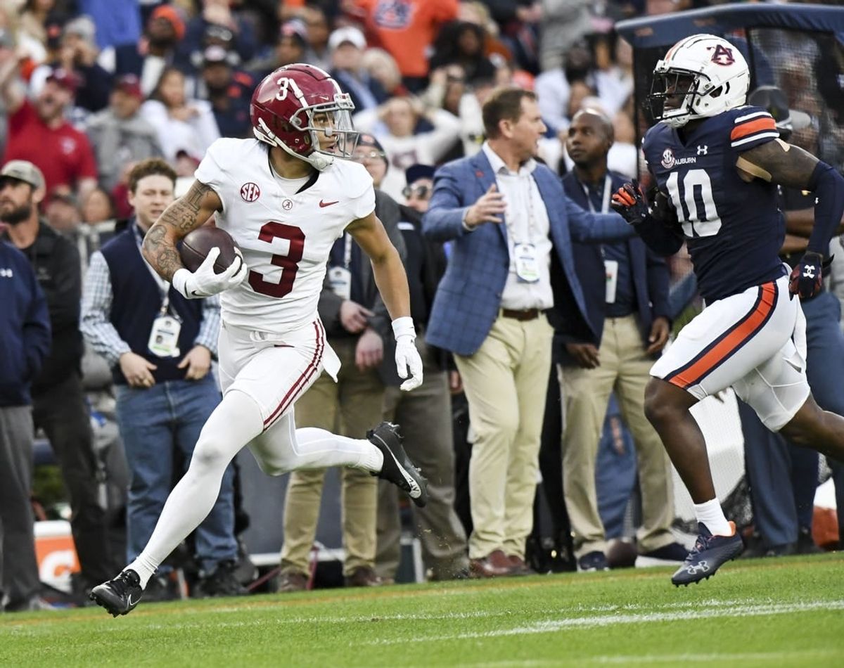 Nov 25, 2023; Auburn, Alabama, USA;  Alabama Crimson Tide wide receiver Jermaine Burton (3) runs against Auburn Tigers safety Zion Puckett (10) for a touchdown at Jordan-Hare Stadium.