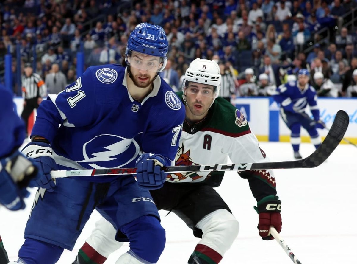 Jan 25, 2024; Tampa, Florida, USA; Tampa Bay Lightning center Anthony Cirelli (71) and Arizona Coyotes center Nick Schmaltz (8) look after the puck during the first period at Amalie Arena.