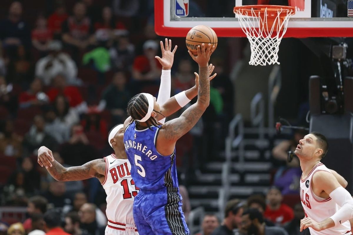 Nov 15, 2023; Chicago, Illinois, USA; Orlando Magic forward Paolo Banchero (5) shoots against Chicago Bulls forward Torrey Craig (13) during the first half at United Center.
