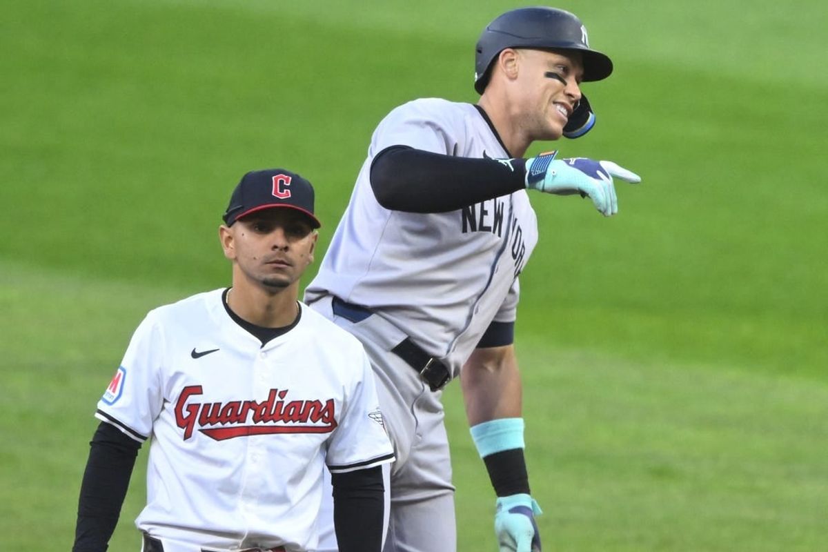 Apr 13, 2024; Cleveland, Ohio, USA; New York Yankees center fielder Aaron Judge (99) celebrates his double beside Cleveland Guardians second baseman Andres Gimenez (0) in the sixth inning at Progressive Field.