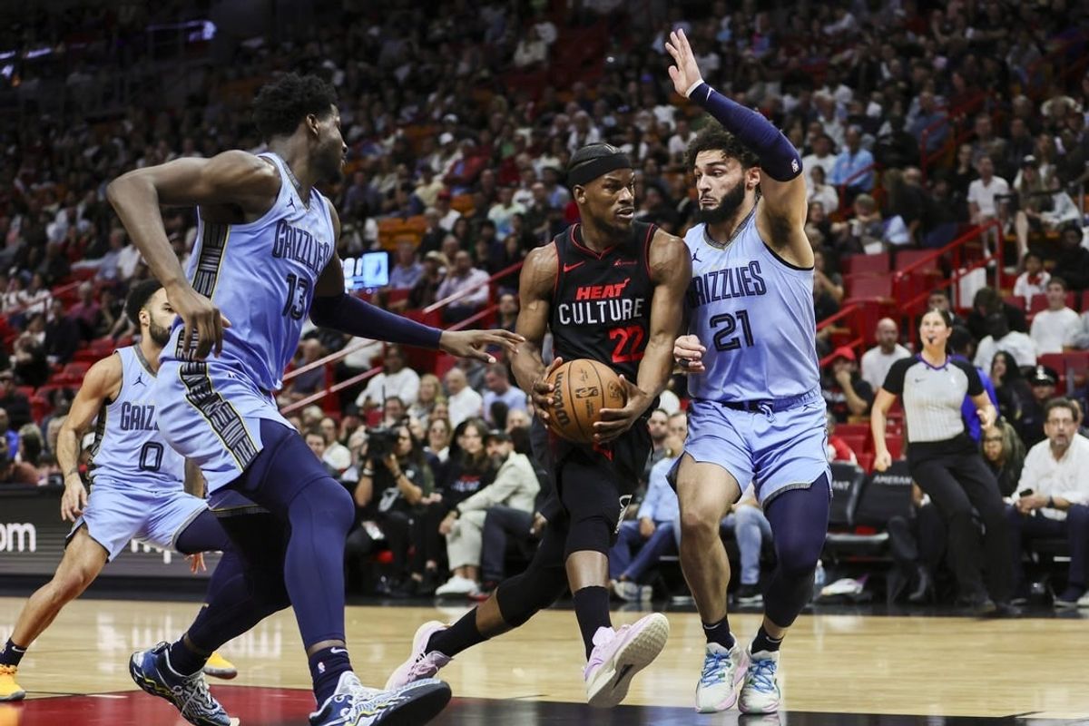 Jan 24, 2024; Miami, Florida, USA; Miami Heat forward Jimmy Butler (22) drives to the basket against Memphis Grizzlies forward David Roddy (21) during the second quarter at Kaseya Center.