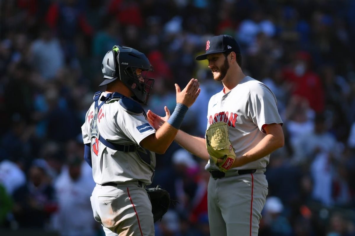 Mar 31, 2024; Seattle, Washington, USA; Boston Red Sox catcher Reese McGuire (3) and relief pitcher Justin Slaten (63) celebrate defeating the Seattle Mariners at T-Mobile Park.