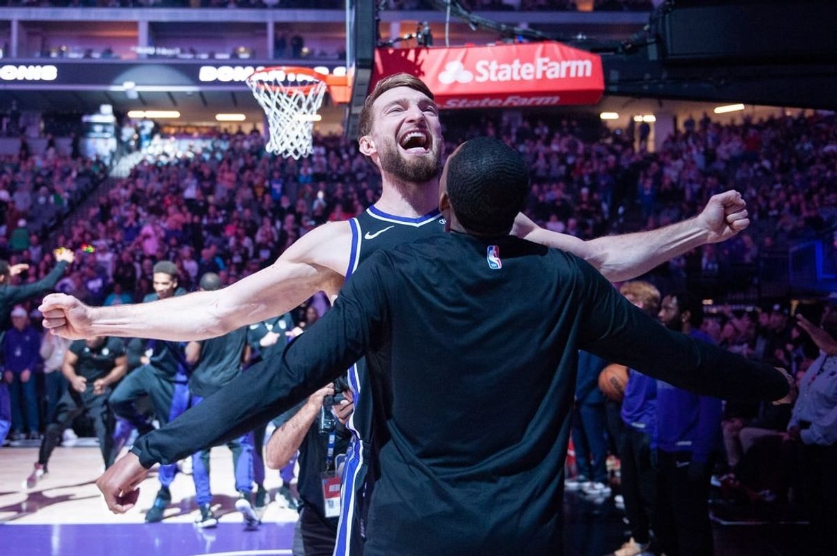 Dec 20, 2023; Sacramento, California, USA; Sacramento Kings forward Domantas Sabonis (10) celebrates with guard De'Aaron Fox (5) during pregame introductions at Golden 1 Center.