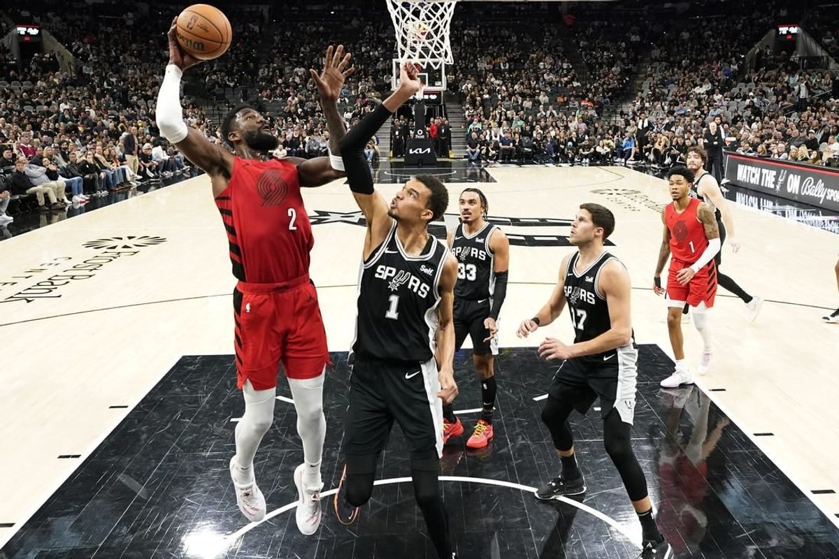 Jan 26, 2024; San Antonio, Texas, USA; Portland Trail Blazers center Deandre Ayton (2) shoots over San Antonio Spurs forward Victor Wembanyama (1) during the first half at Frost Bank Center.