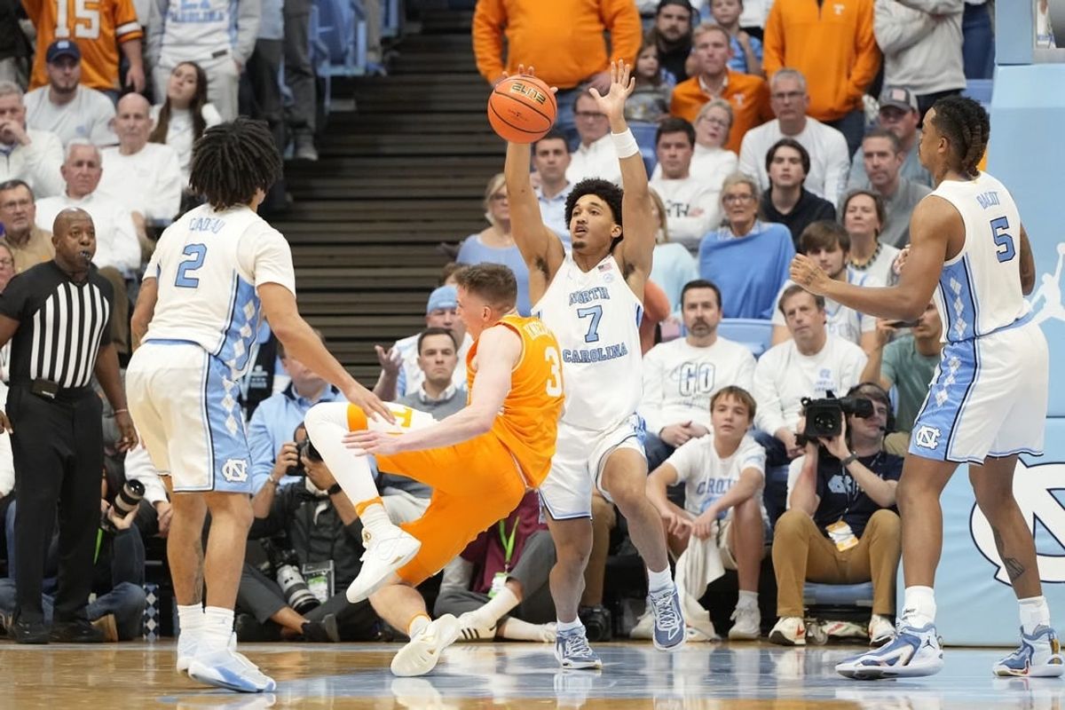 Nov 29, 2023; Chapel Hill, North Carolina, USA; Tennessee Volunteers guard Dalton Knecht (3) trips as North Carolina Tar Heels guard Seth Trimble (7) defends in the second half at Dean E. Smith Center.