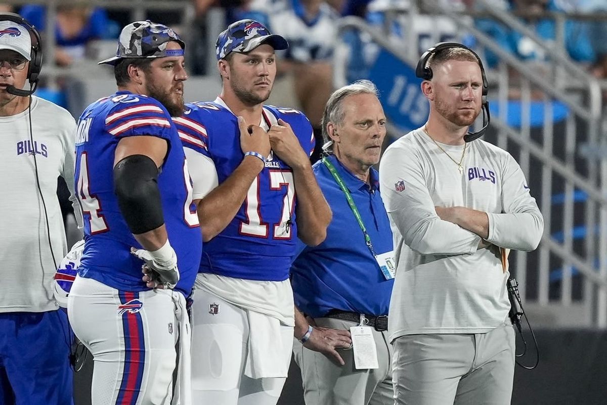 Aug 26, 2022; Charlotte, North Carolina, USA; Buffalo Bills guard Greg Van Roten (64), quarterback Josh Allen (17) and offensive coach Joe Brady watch as Carolina Panthers quarterback Sam Darnold (not pictured) is carted off the field during the second half at Bank of America Stadium.