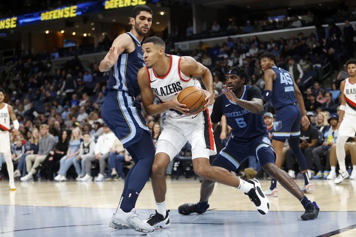 Mar 1, 2024; Memphis, Tennessee, USA; Portland Trail Blazers forward Kris Murray (8) drives to the basket as Memphis Grizzlies forward-center Santi Aldama (7) and Memphis Grizzlies guard Vince Williams Jr. (5) defend during the first half at FedExForum.