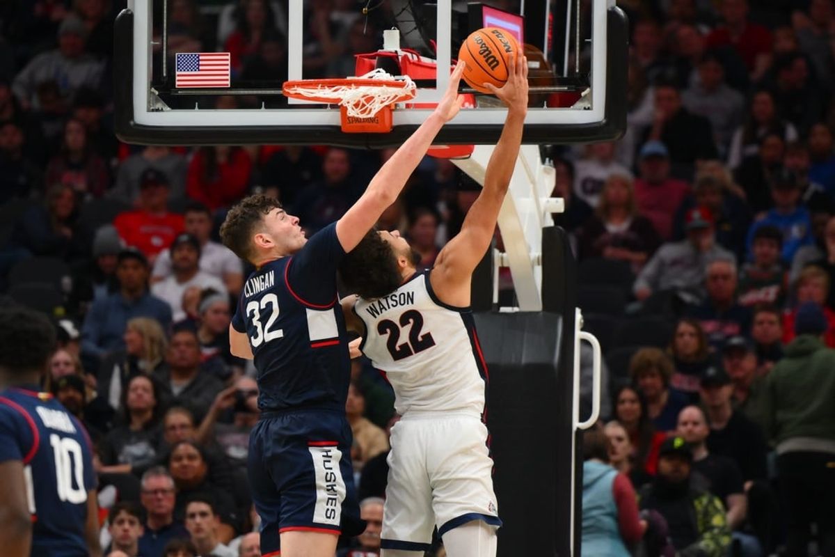 Dec 15, 2023; Seattle, Washington, USA; Connecticut Huskies center Donovan Clingan (32) blocks a shot attempt by Gonzaga Bulldogs forward Anton Watson (22) during the second half at Climate Pledge Arena.
