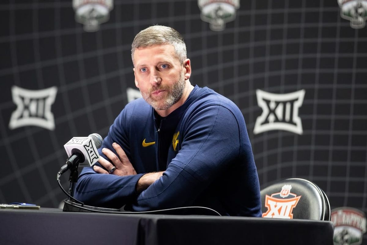 Oct 18, Kansas City, MO, USA; West Virginia interim head coach Josh Eilert answers questions at Big 12 Men s Basketball Tipoff at T-Mobile Center.