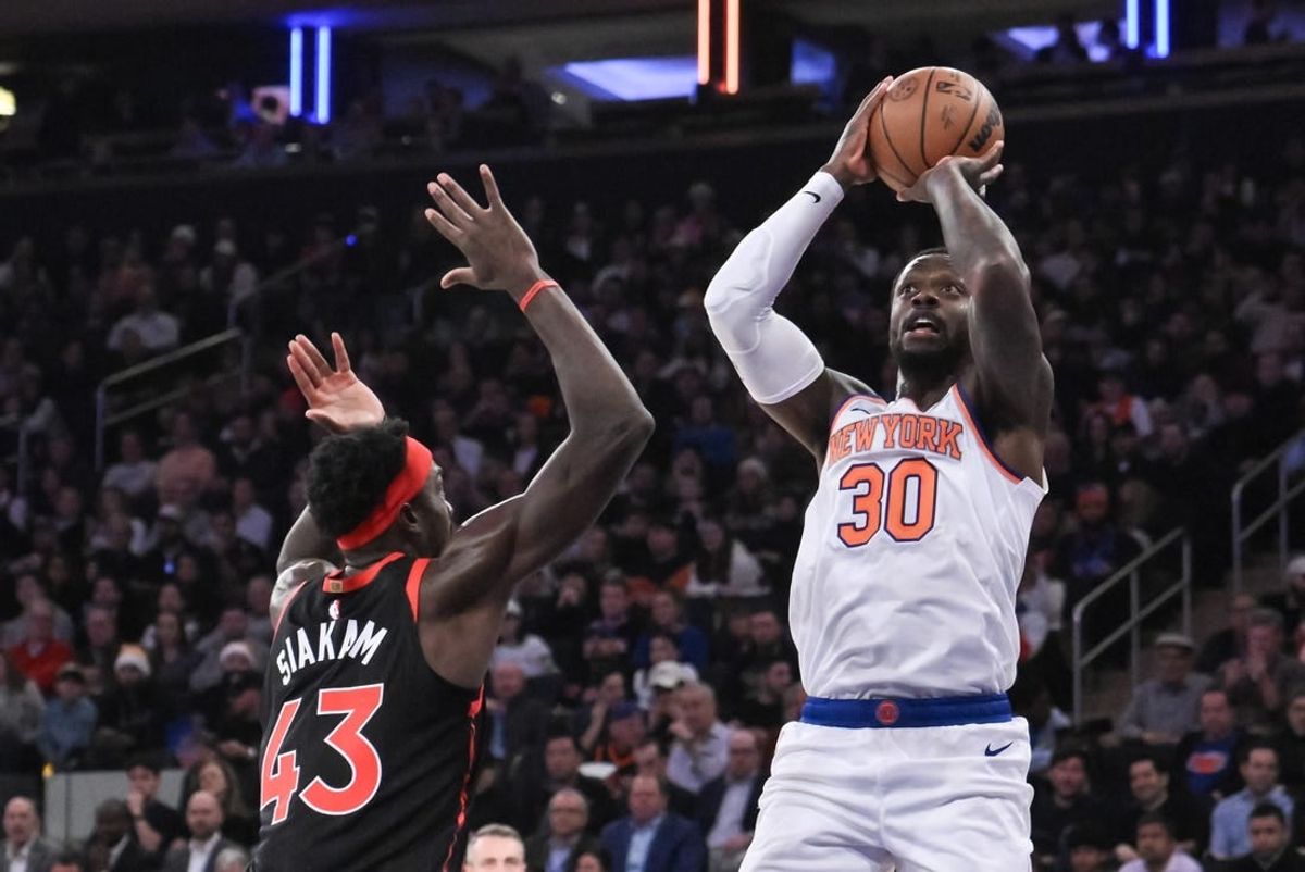Dec 11, 2023; New York, New York, USA; New York Knicks forward Julius Randle (30) shoots the ball while being defended by Toronto Raptors forward Pascal Siakam (43) during the first quarter at Madison Square Garden.