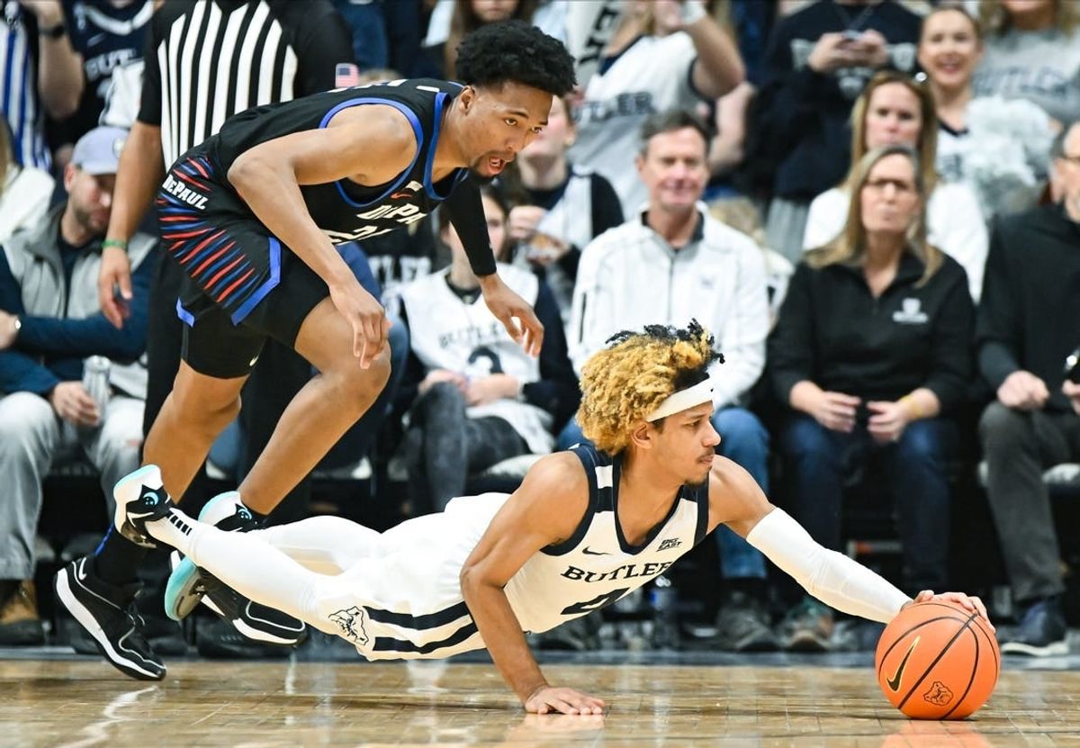 Jan 20, 2024; Indianapolis, Indiana, USA;  Butler Bulldogs guard DJ Davis (4) dives for the ball in front of DePaul Blue Demons forward Jeremiah Oden (25) during the first half at Hinkle Fieldhouse.