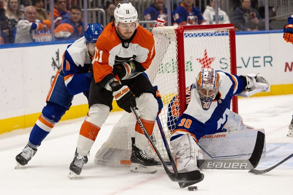 Nov 25, 2023; Elmont, New York, USA; Philadelphia Flyers right wing Travis Konecny (11) with the puck in front of New York Islanders goaltender Ilya Sorokin (30) during the first period at UBS Arena.