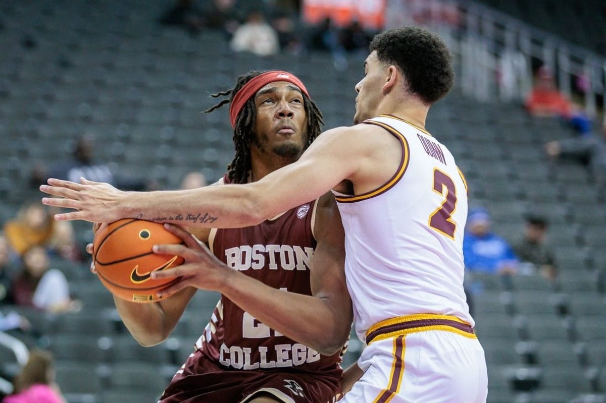 Nov 23, 2023; Kansas City, Missouri, USA; Boston College Eagles forward Devin McGlockton (21) tries to get around Loyola (Il) Ramblers guard Jalen Quinn (2) during the first half at T-Mobile Center.