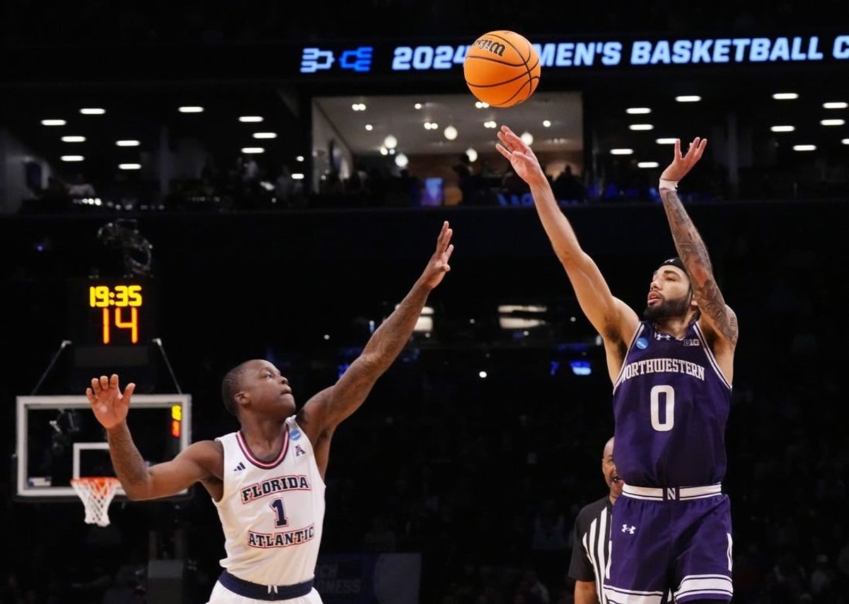 March 22, 2024, Brooklyn, NY, USA; Northwestern Wildcats guard Boo Buie (0) shoots over Florida Atlantic Owls guard Johnell Davis (1)  in the first round of the 2024 NCAA Tournament at the Barclays Center.