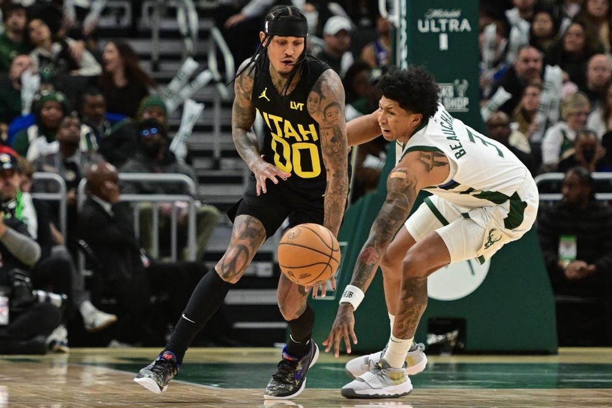 Jan 8, 2024; Milwaukee, Wisconsin, USA; Utah Jazz guard Jordan Clarkson (00) and Milwaukee Bucks guard MarJon Beauchamp (3) reach for a loose ball in the third quarter at Fiserv Forum.