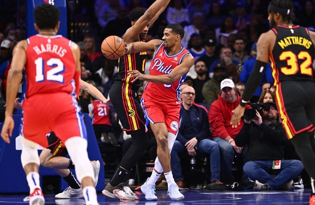 Dec 8, 2023; Philadelphia, Pennsylvania, USA; Philadelphia 76ers guard De'Anthony Melton (8) passes the ball against Atlanta Hawks forward De'Andre Hunter (12) in the first quarter at Wells Fargo Center.