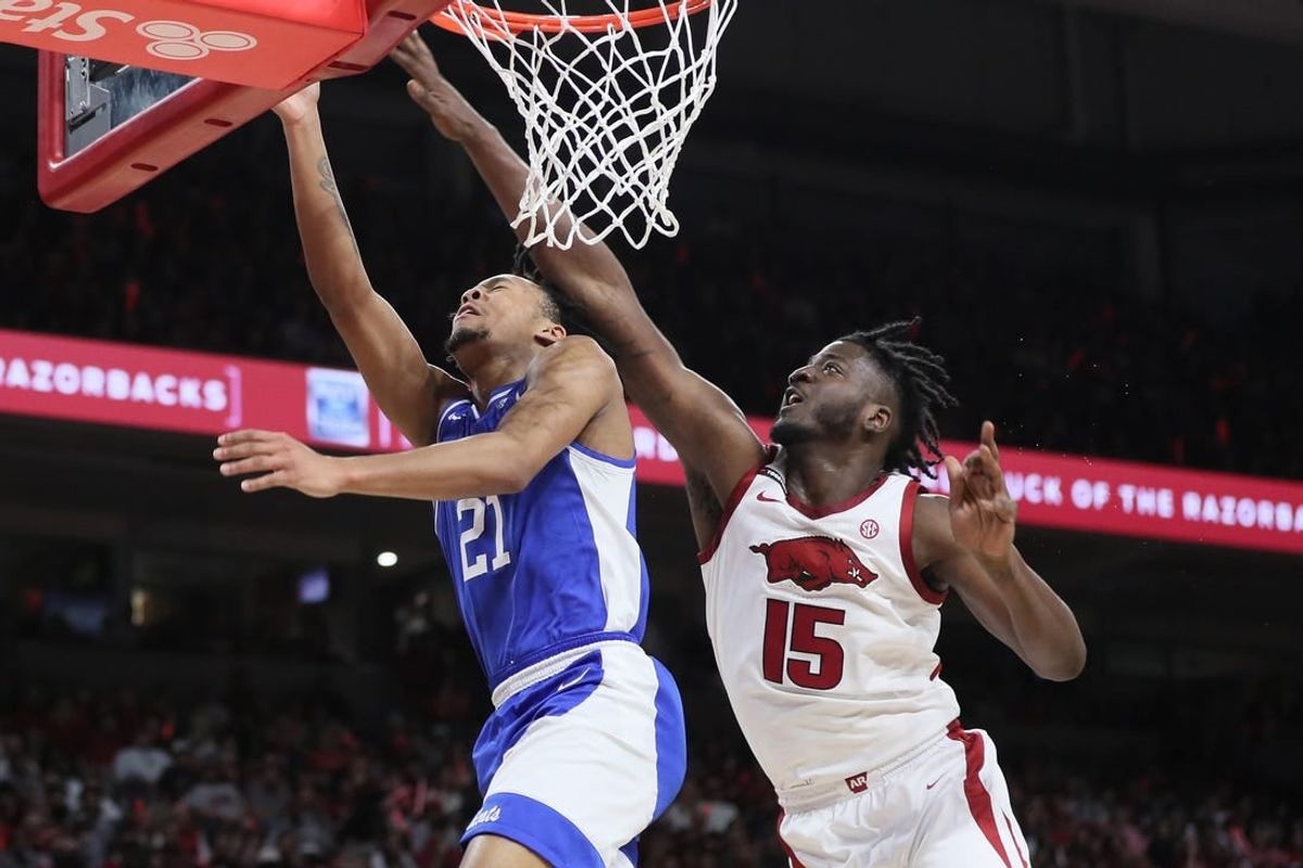 Jan 27, 2024; Fayetteville, Arkansas, USA; Kentucky Wildcats guard D.J. Wagner (21) drives to the basket during the first half as Arkansas Razorbacks forward Makhi Mitchell (15) defends at Bud Walton Arena.