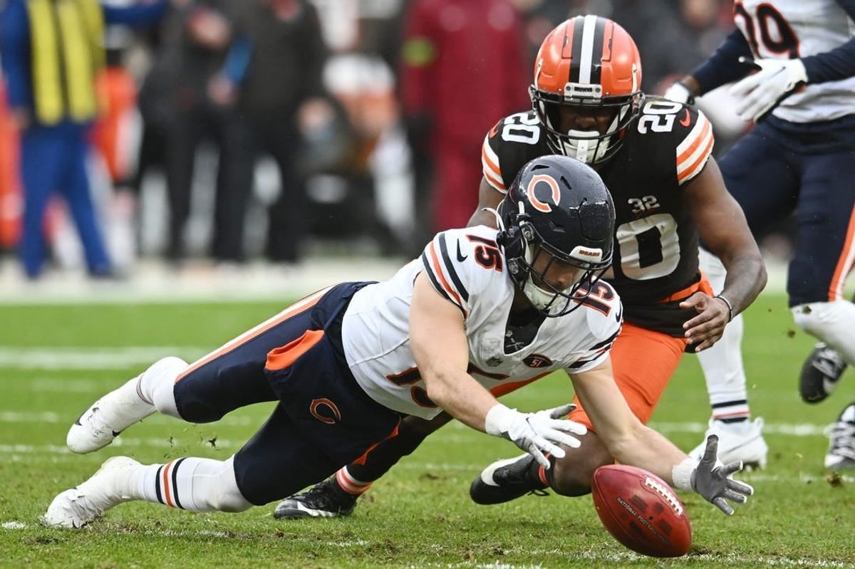 Dec 17, 2023; Cleveland, Ohio, USA; Chicago Bears wide receiver Trent Taylor (15) recovers a muffed punt as Cleveland Browns running back Pierre Strong Jr. (20) defends during the first quarter at Cleveland Browns Stadium.