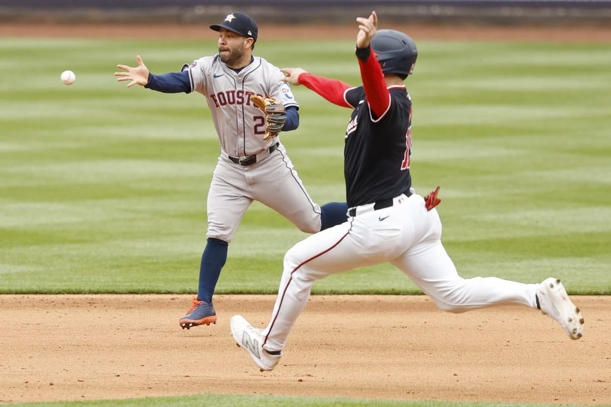 Apr 21, 2024; Washington, District of Columbia, USA; Houston Astros second base Jose Altuve (27) makes a play to second base ahead of a slide by Washington Nationals catcher Riley Adams (15) during the fifth inning at Nationals Park.