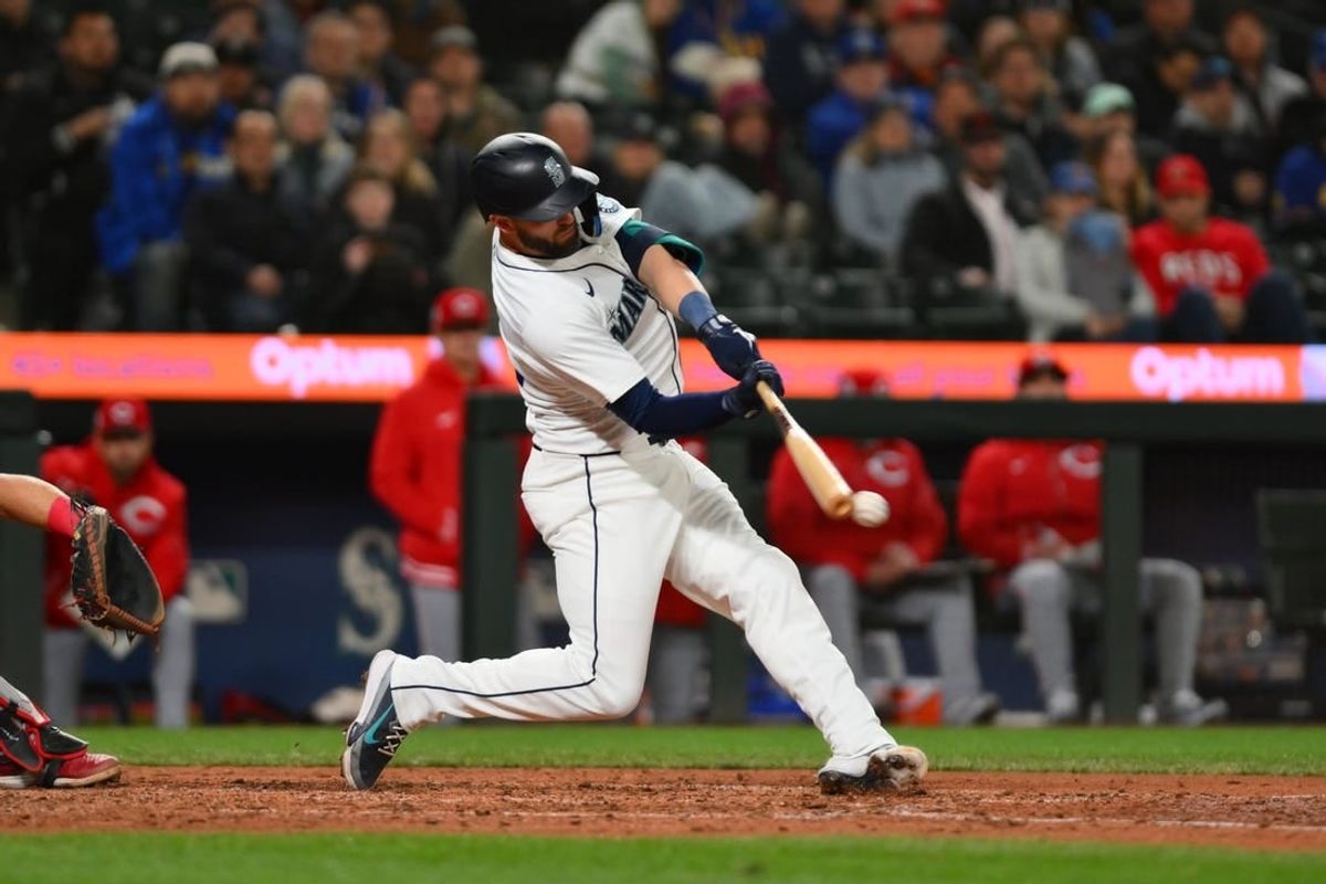 Apr 15, 2024; Seattle, Washington, USA; Seattle Mariners right fielder Mitch Haniger hits an RBI double against the Cincinnati Reds during the seventh inning at T-Mobile Park. All players wore #42 in honor of Jackie Robinson Day.
