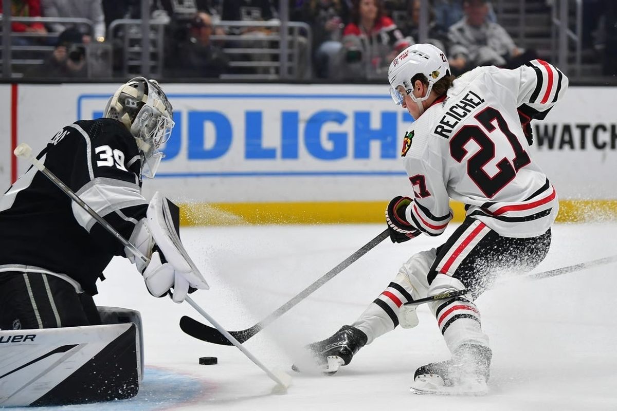 Apr 18, 2024; Los Angeles, California, USA; Chicago Blackhawks left wing Lukas Reichel (27) scores a goal against Los Angeles Kings goaltender Cam Talbot (39) during the first period at Crypto.com Arena.