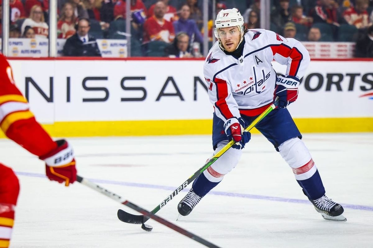 Mar 18, 2024; Calgary, Alberta, CAN; Washington Capitals right wing T.J. Oshie (77) controls the puck against the Calgary Flames during the third period at Scotiabank Saddledome.