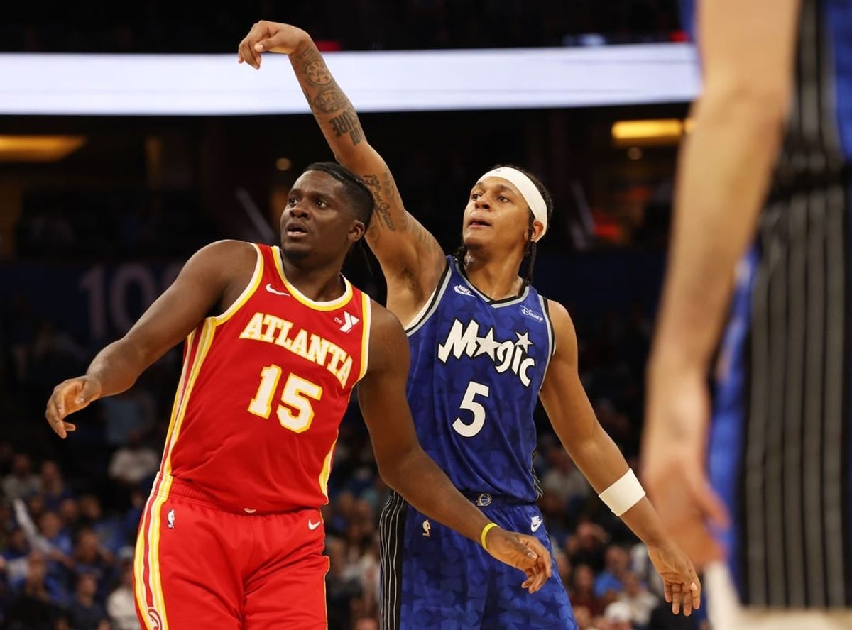 Jan 7, 2024; Orlando, Florida, USA; Orlando Magic forward Paolo Banchero (5) makes a three pointer over Atlanta Hawks center Clint Capela (15) during overtime at Kia Center.