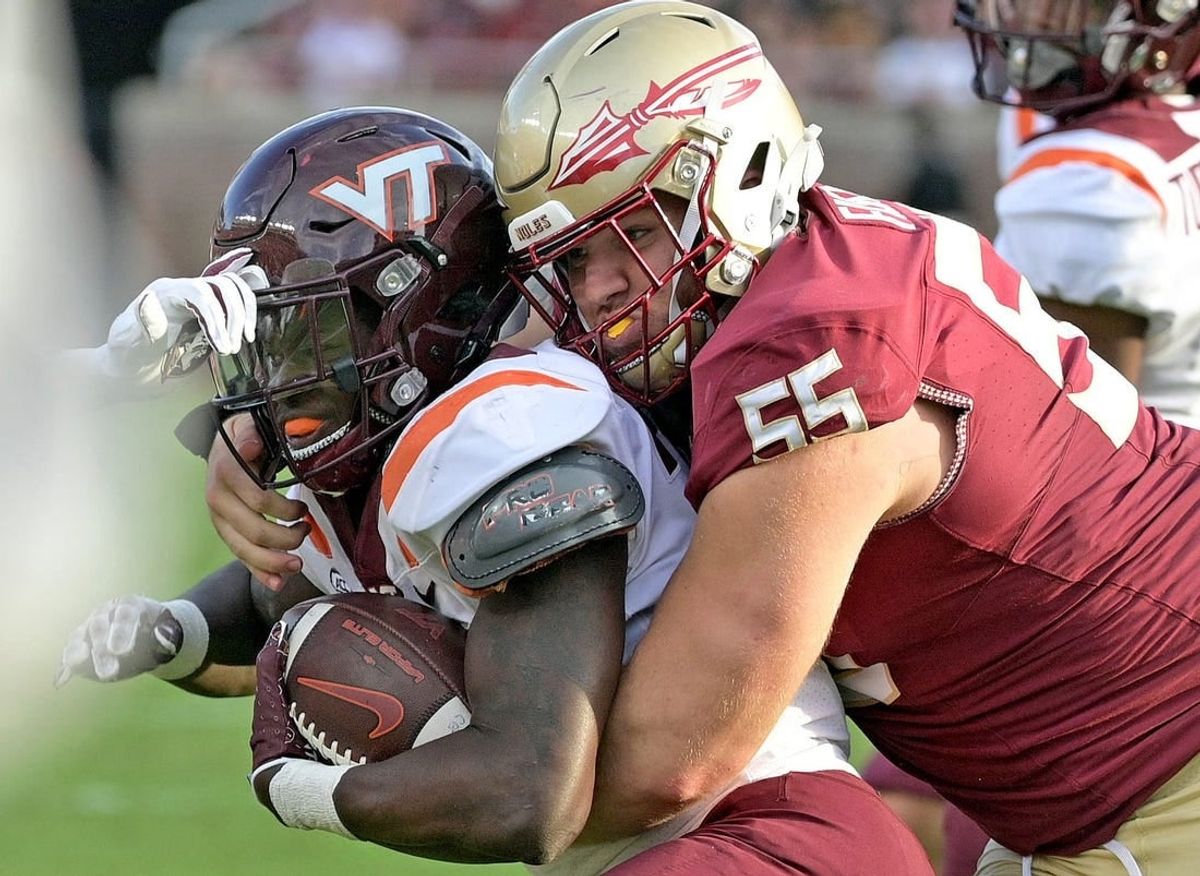 Oct 7, 2023; Tallahassee, Florida, USA; Virginia Tech Hokies running back Malachi Thomas (24) is tackled by Florida State Seminoles defensive lineman Braden Fiske (55) during the second half at Doak S. Campbell Stadium.