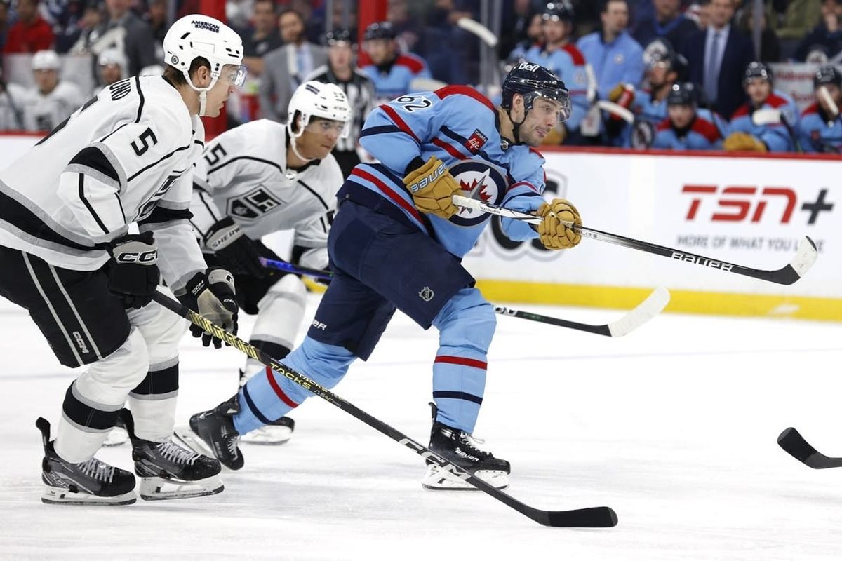 Apr 1, 2024; Winnipeg, Manitoba, CAN; Winnipeg Jets right wing Nino Niederreiter (62) takes a shot watched by Los Angeles Kings defenseman Andreas Englund (5) in the second period at Canada Life Centre.