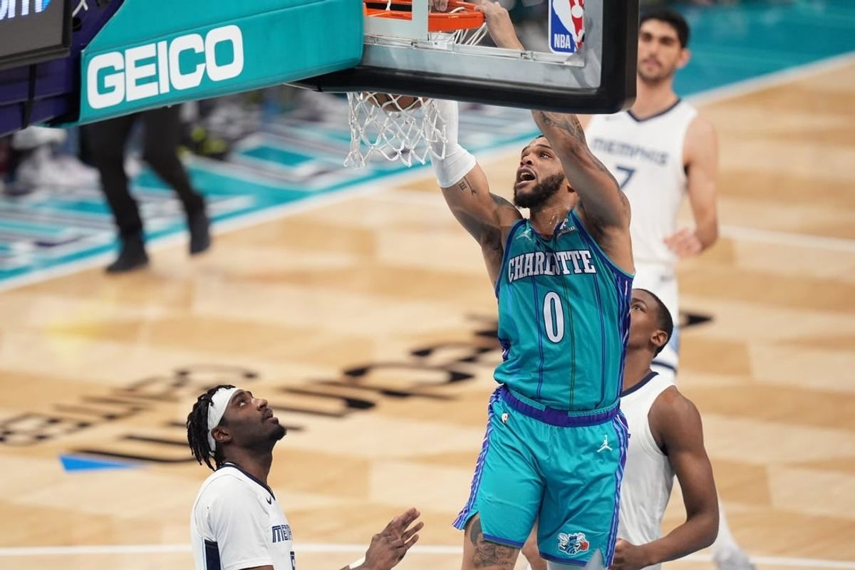 Feb 10, 2024; Charlotte, North Carolina, USA; Charlotte Hornets forward Miles Bridges (0) goes up for a dunk against the Memphis Grizzlies during the second quarter at Spectrum Center.