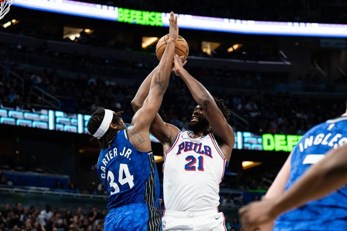 Jan 19, 2024; Orlando, Florida, USA; Philadelphia 76ers center Joel Embiid (21) shoots the ball over Orlando Magic center Wendell Carter Jr. (34) in the second quarter at KIA Center.