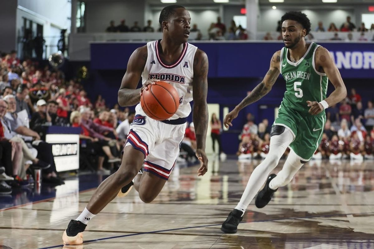 Jan 28, 2024; Boca Raton, Florida, USA; Florida Atlantic Owls guard Johnell Davis (1) drives to the basket past North Texas Mean Green guard Rondel Walker (5) during the second half at Eleanor R. Baldwin Arena.