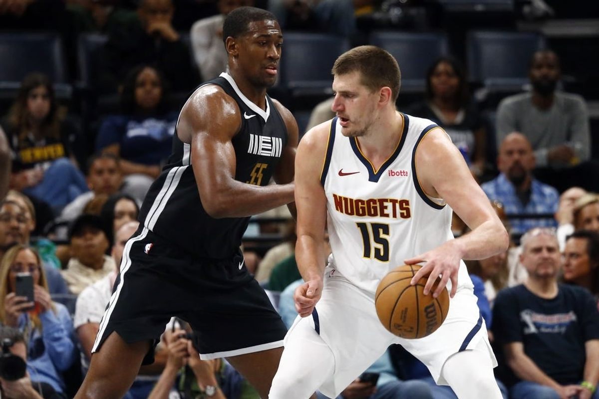 Apr 14, 2024; Memphis, Tennessee, USA; Denver Nuggets center Nikola Jokic (15) dribbles as Memphis Grizzlies center Trey Jemison (55) defends during the second half at FedExForum.