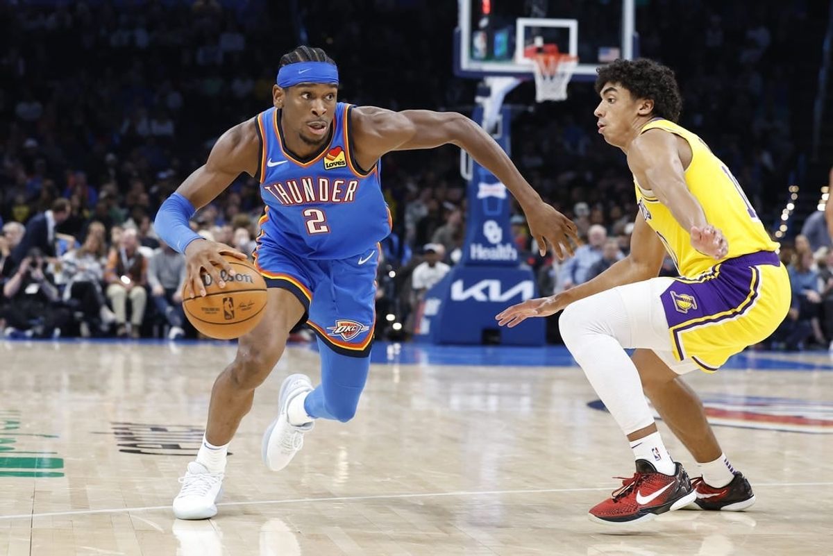 Nov 30, 2023; Oklahoma City, Oklahoma, USA; Oklahoma City Thunder guard Shai Gilgeous-Alexander (2) drives around Los Angeles Lakers guard Max Christie (10) during the second half at Paycom Center.