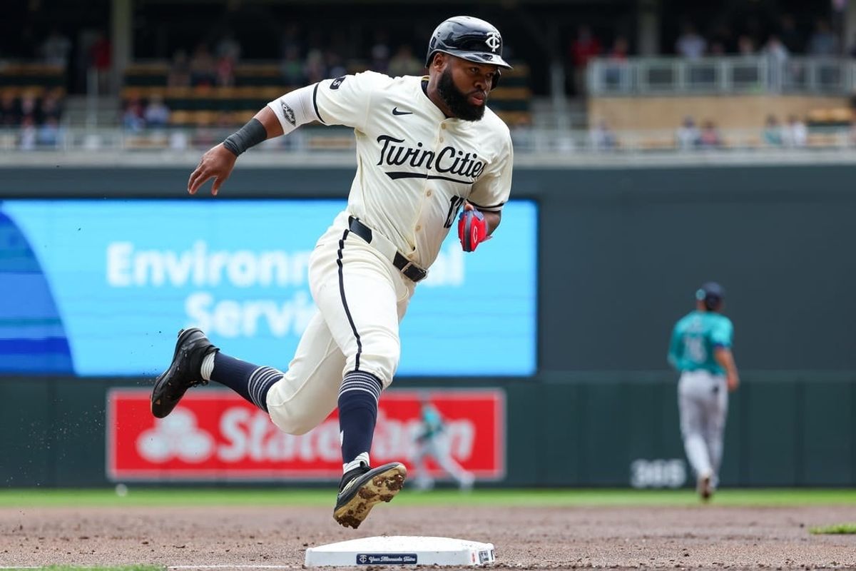 May 9, 2024; Minneapolis, Minnesota, USA; Minnesota Twins Manuel Margot (13) scores on a single hit by Carlos Santana (30) against the Seattle Mariners during the first inning at Target Field.