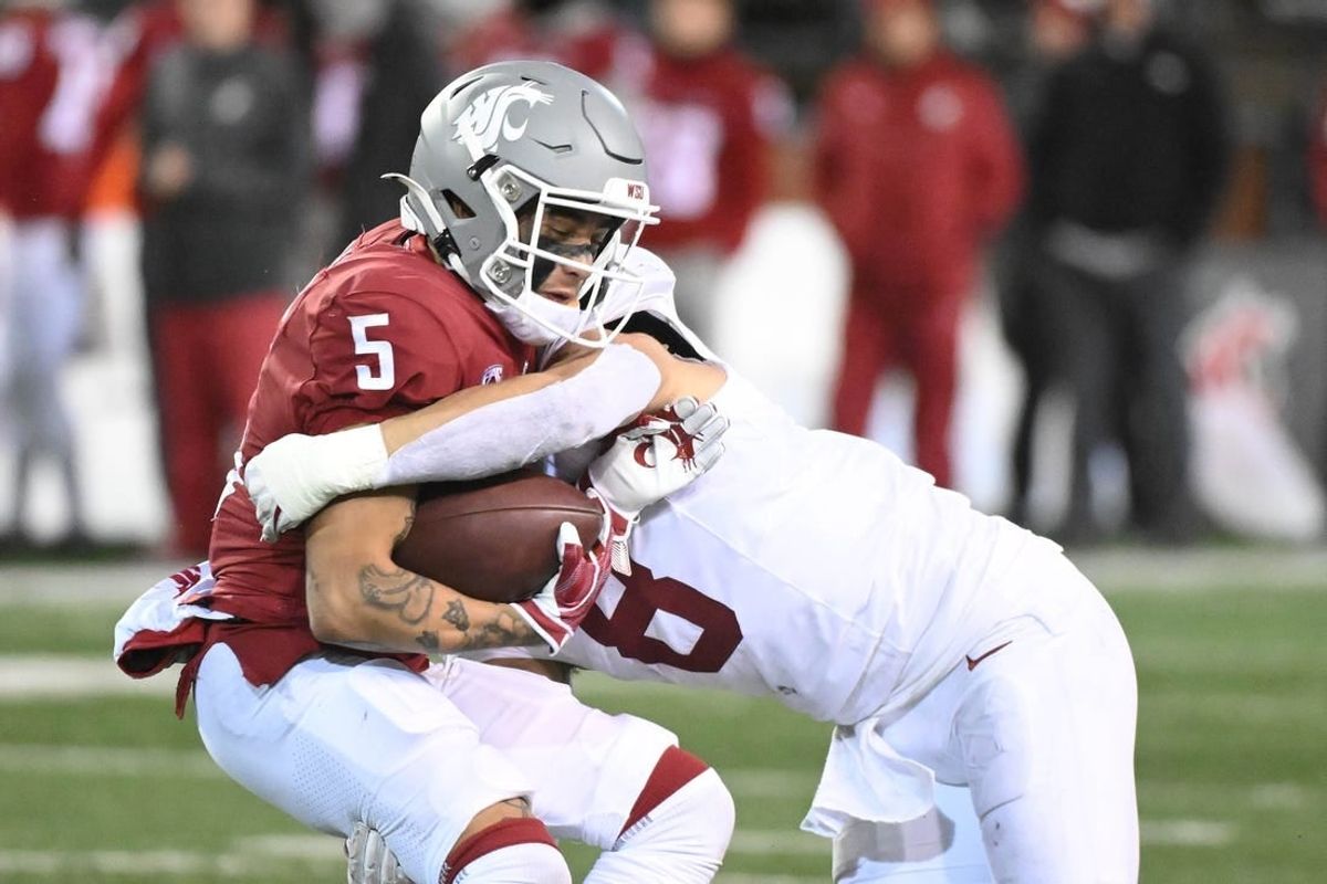 Nov 4, 2023; Pullman, Washington, USA; Washington State Cougars wide receiver Lincoln Victor (5) is stopped alert short gain by Stanford Cardinal linebacker Tristan Sinclair (8) in the second half at Gesa Field at Martin Stadium. Stanford won 10-7.