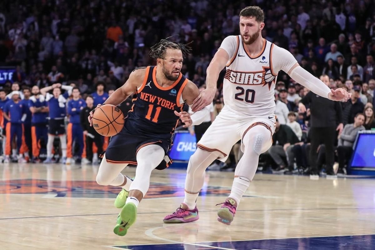 Nov 26, 2023; New York, New York, USA; New York Knicks guard Jalen Brunson (11) drives past Phoenix Suns center Jusuf Nurkic (20) in the fourth quarter at Madison Square Garden.