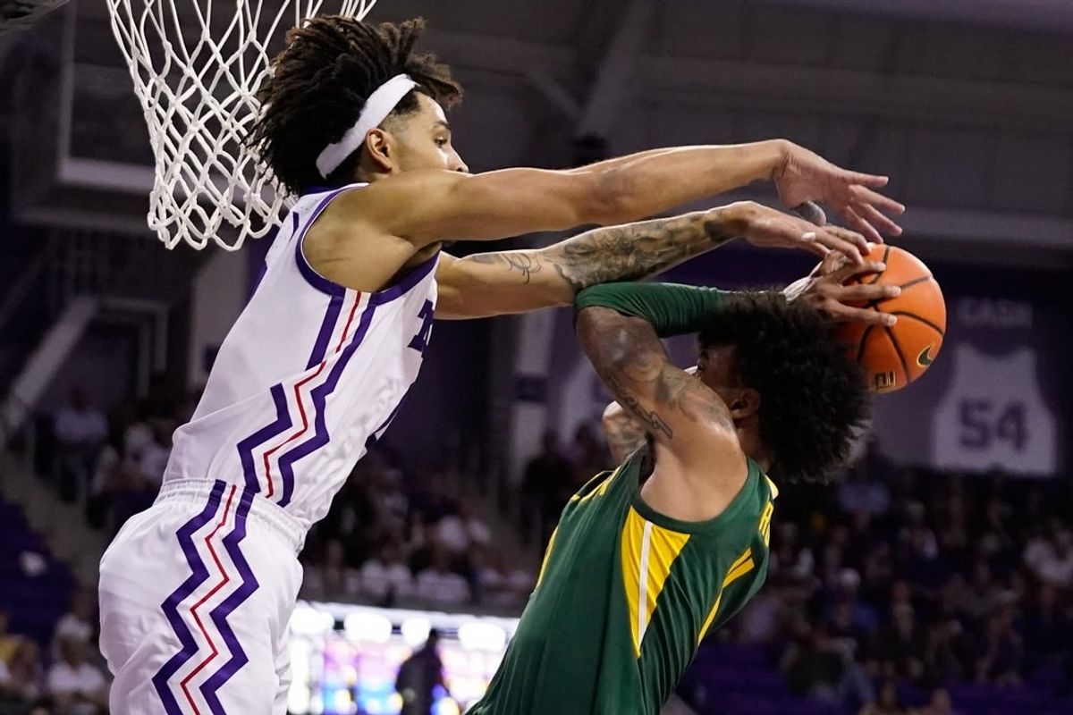 Feb 26, 2024; Fort Worth, Texas, USA; TCU Horned Frogs guard Micah Peavy (0) defends Baylor Bears forward Jalen Bridges (11) during the second half at Ed and Rae Schollmaier Arena.