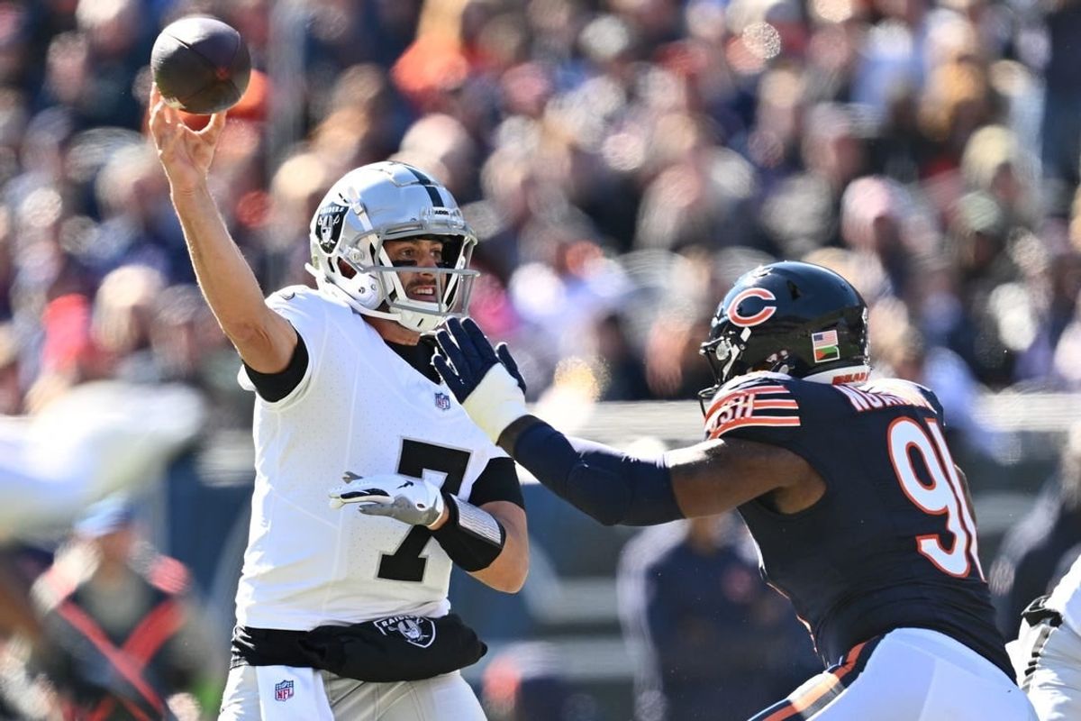 Oct 22, 2023; Chicago, Illinois, USA;  Las Vegas Raiders quarterback Brian Hoyer (7) gets off a pass while being pressured by Chicago Bears defensive lineman Yannick Ngakoue (91) in the second quarter at Soldier Field.