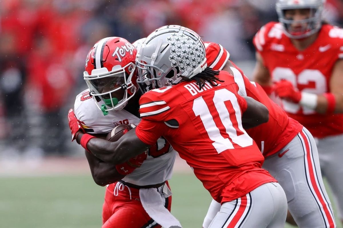Oct 7, 2023; Columbus, Ohio, USA;  Maryland Terrapins wide receiver Tai Felton (10) runs the ball as Ohio State Buckeyes cornerback Denzel Burke (10) makes the tackle during the second quarter at Ohio Stadium.