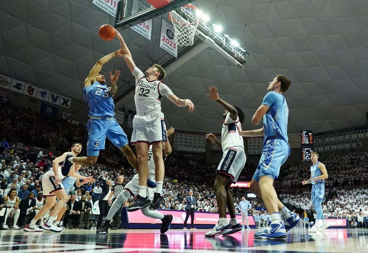 Jan 17, 2024; Storrs, Connecticut, USA; Connecticut Huskies center Donovan Clingan (32) blocks the shot of Creighton Bluejays guard Trey Alexander (23) in the first half at Harry A. Gampel Pavilion.