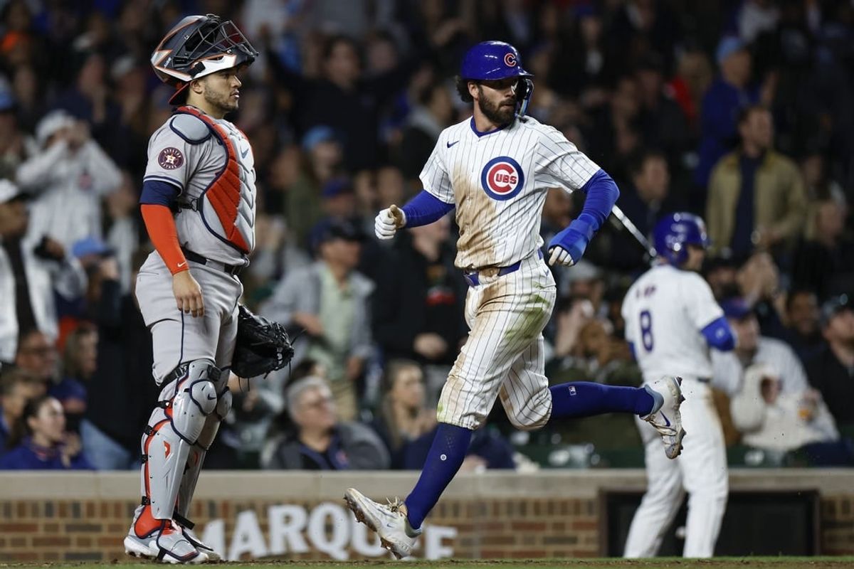 Apr 23, 2024; Chicago, Illinois, USA; Chicago Cubs shortstop Dansby Swanson (7) scores against the Houston Astros during the sixth inning at Wrigley Field.