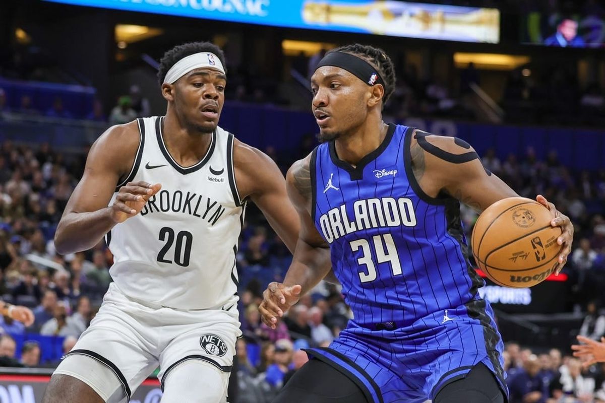 Feb 27, 2024; Orlando, Florida, USA; Orlando Magic center Wendell Carter Jr. (34) drives to the basket against Brooklyn Nets center Day'Ron Sharpe (20) during the first quarter at Amway Center.