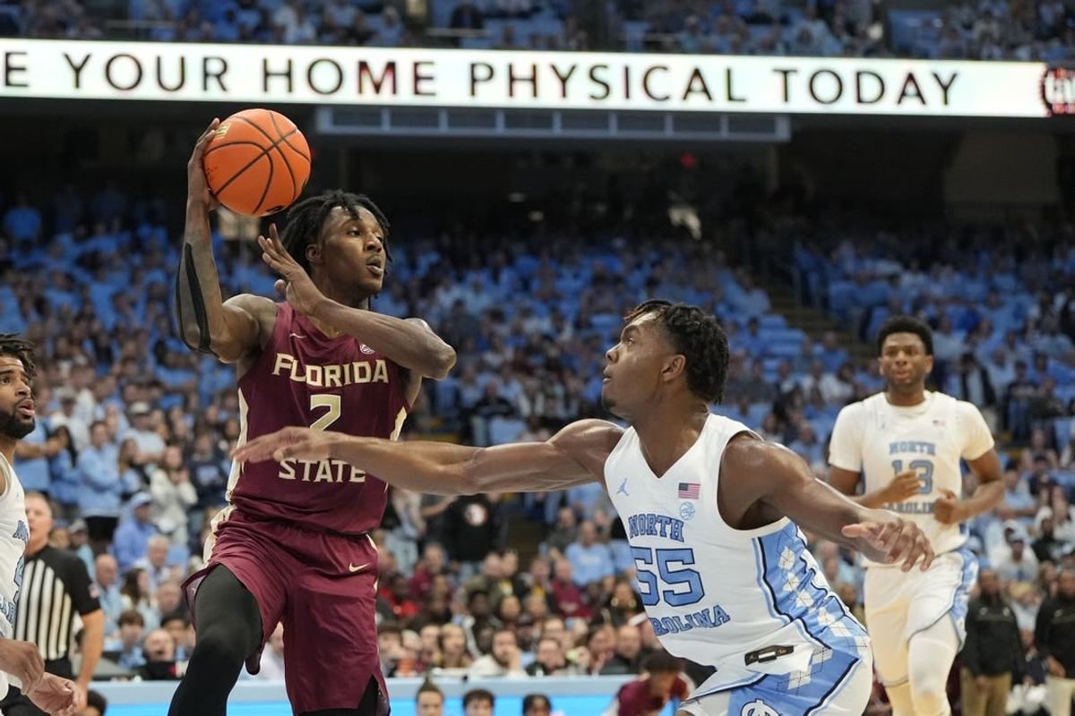 Dec 2, 2023; Chapel Hill, North Carolina, USA;  Florida State Seminoles forward Jamir Watkins (2) with the ball as North Carolina Tar Heels forward Harrison Ingram (55) defends in the first half at Dean E. Smith Center.