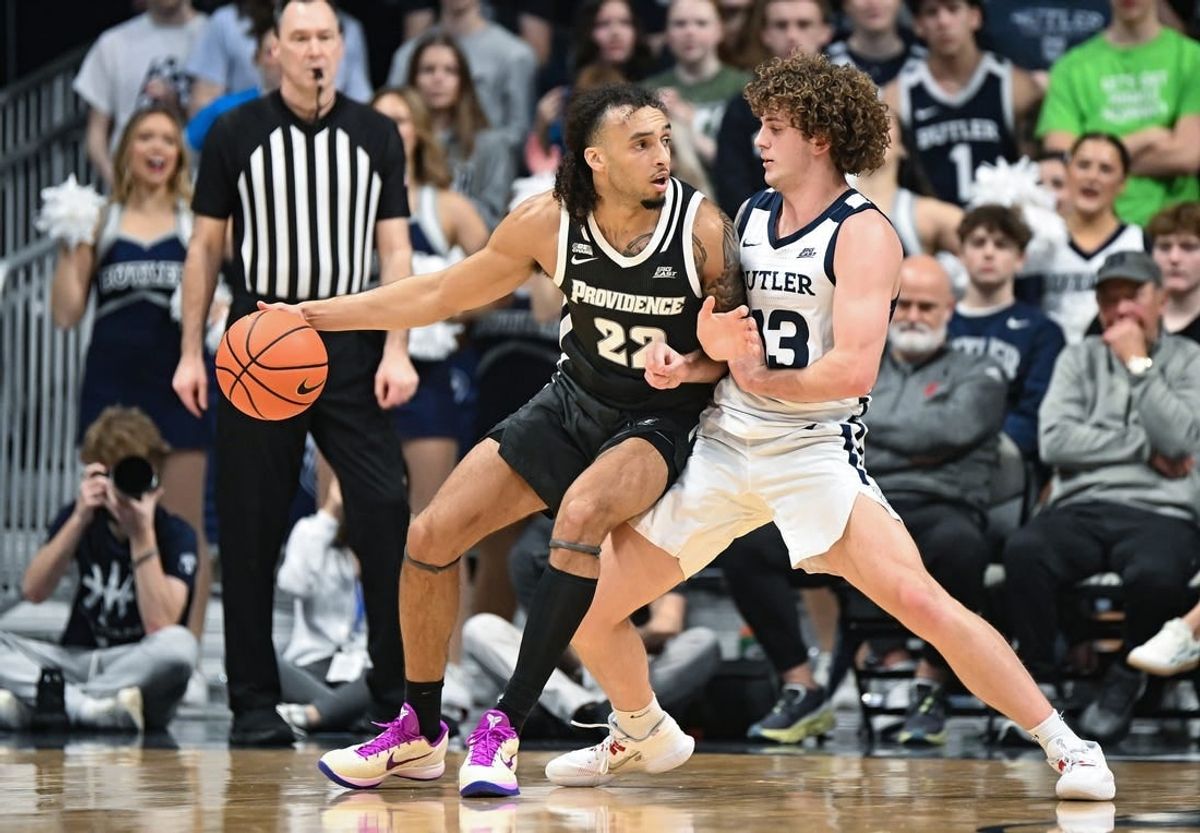 Feb 10, 2024; Indianapolis, Indiana, USA;  Providence Friars guard Devin Carter (22) dribbles against Butler Bulldogs guard Finley Bizjack (13) during the first half at Hinkle Fieldhouse.