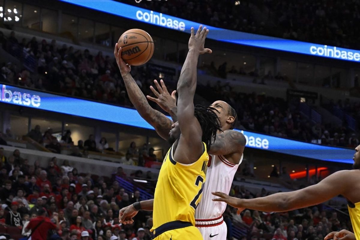 Dec 28, 2023; Chicago, Illinois, USA;  Chicago Bulls forward DeMar DeRozan (11) shoots against Indiana Pacers forward Aaron Nesmith (23)  during the first half at United Center.