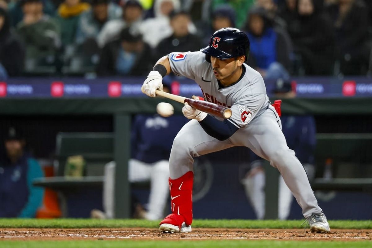 Apr 2, 2024; Seattle, Washington, USA; Cleveland Guardians left fielder Steven Kwan (38) bunts for a single against the Seattle Mariners during the fifth inning at T-Mobile Park.