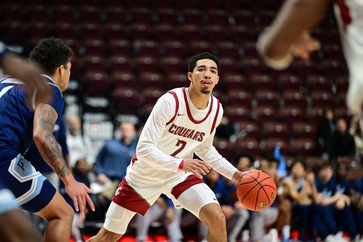 Nov 19, 2023; Uncasville, CT, USA; Washington State Cougars guard Myles Rice (2) dribbles the ball defended by Rhode Island Rams guard Luis Kortright (1) during the second half at Mohegan Sun Arena.