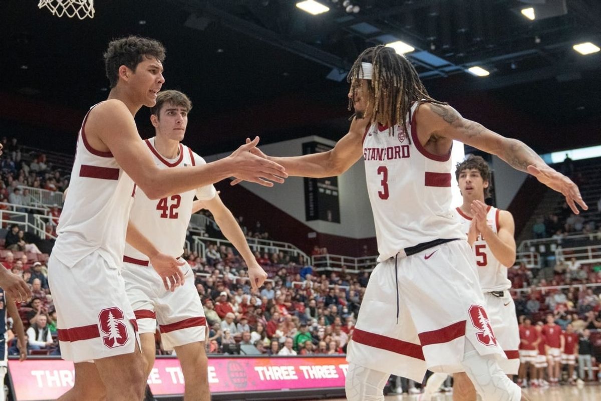 Dec 31, 2023; Stanford, California, USA; Stanford Cardinal guard Kanaan Carlyle (3) celebrates with forward Brandon Angel (23) and his teammates during the second half against the Arizona Wildcats at Maples Pavilion.